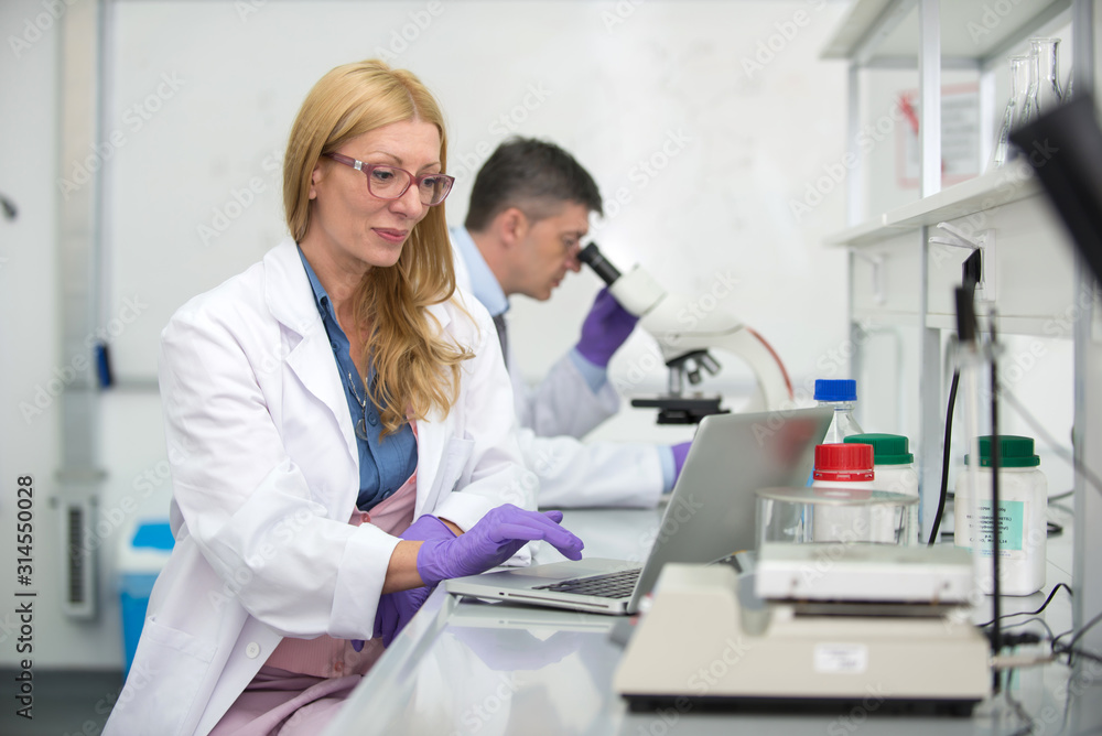 Laboratory scientists researching chemical compositions Laboratory scientists researching chemical compositions
