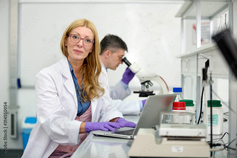 Laboratory scientists researching chemical compositions Laboratory scientists researching chemical compositions