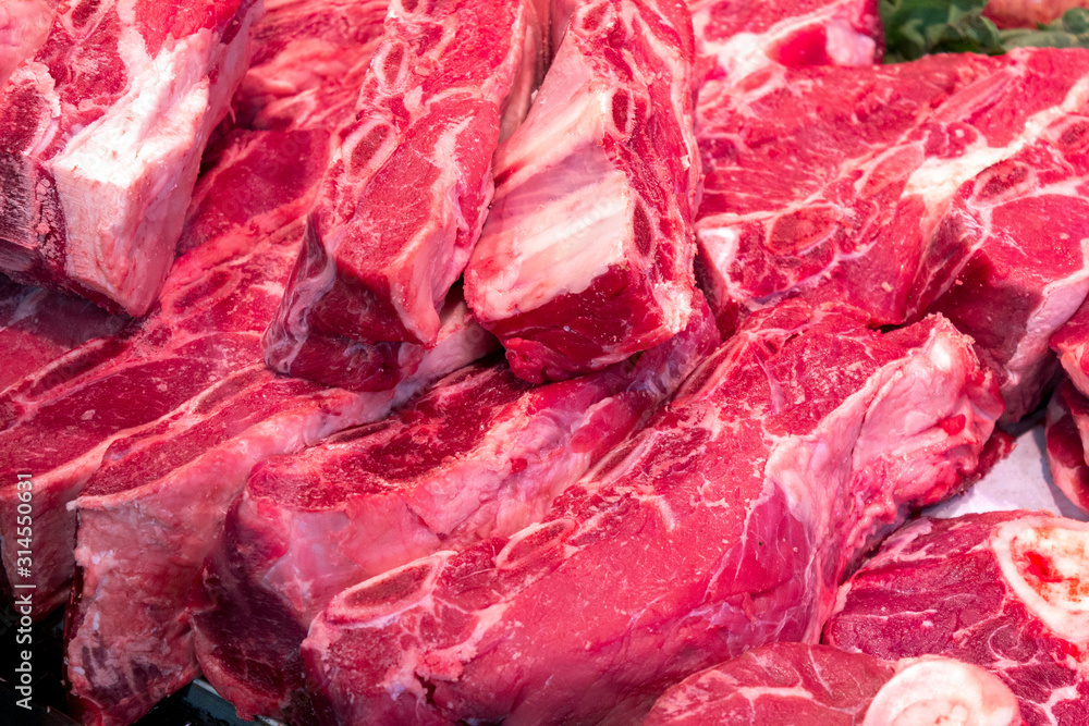 Showcase with raw meat in butcher shop. Fresh meat in supermarket. Healthy food concept Showcase with raw meat in butcher shop. Fresh meat in supermarket. Healthy food concept
