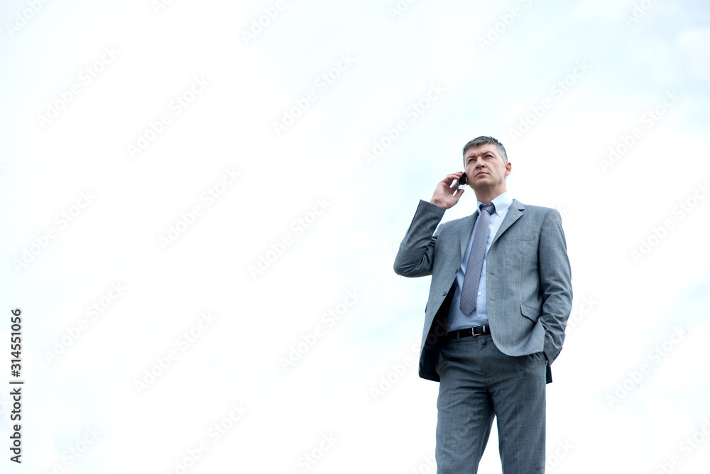 Businessman out of the office talking on his phone Businessman out of the office talking on his phone