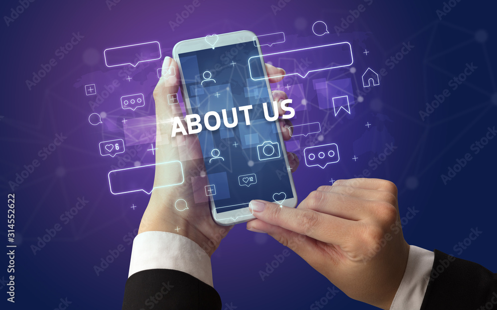 Female hand typing on smartphone with ABOUT US inscription, social media concept Female hand typing on smartphone with ABOUT US inscription, social media concept