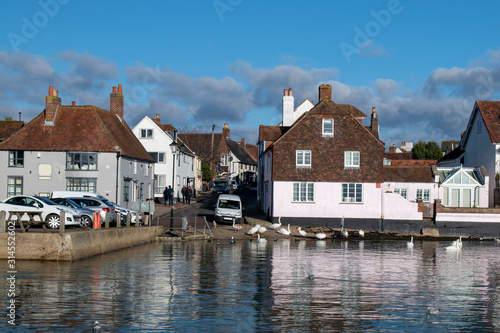 Emsworth harbour a beautiful view of small boats Swans and buildings reflecting in the water.