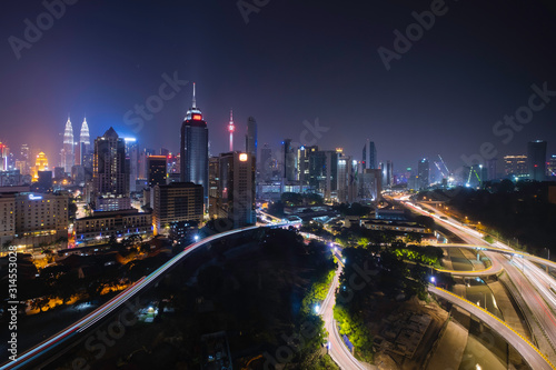 Photography Kuala lumpur skyline at night with car light trail in highway, Cityscape of kuala lumpur city the center of business