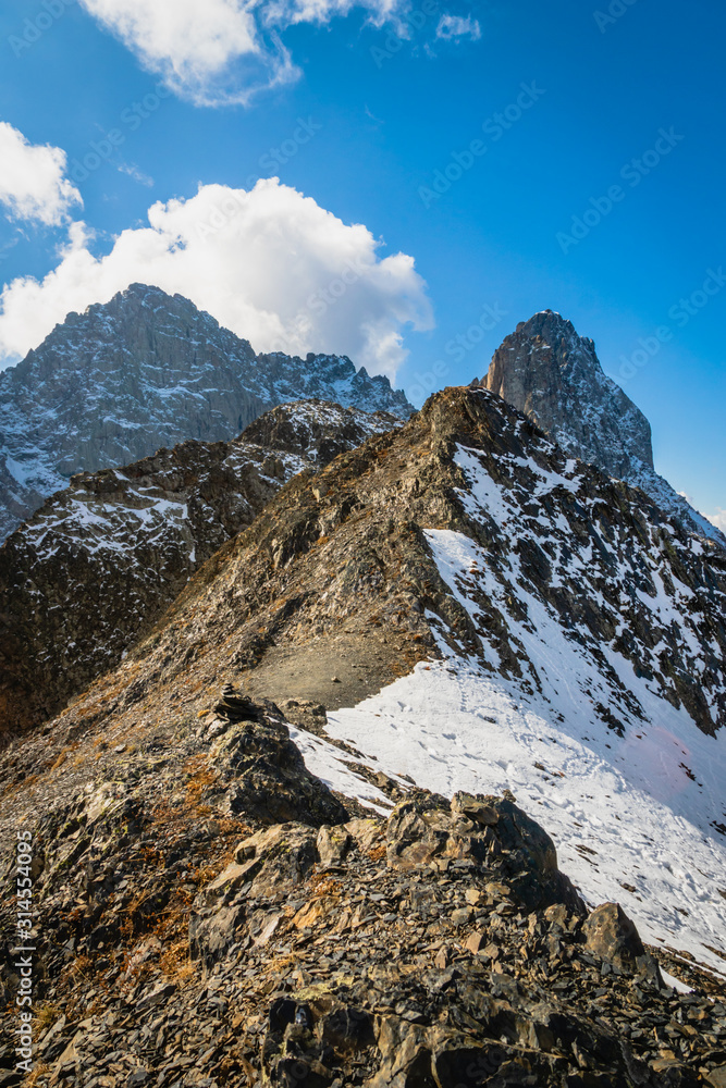 dramatic mountain landscape in Juta trekking area landscape with snowy  mountains in sunny autumn day -  popular trekking  in the Caucasus mountains, Kazbegi region, Georgia.