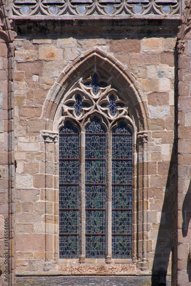 Pointed ogive arch with gothic window at Tréguier cathedral in Brittany, France