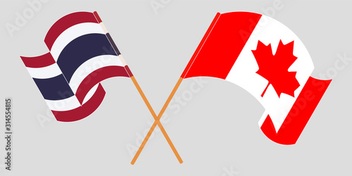 Crossed and waving flags of Thailand and Canada