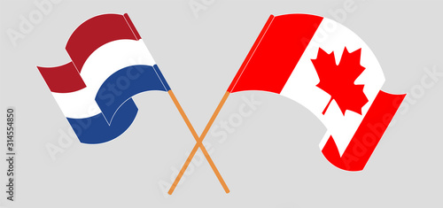 Crossed and waving flags of Canada and Netherlands