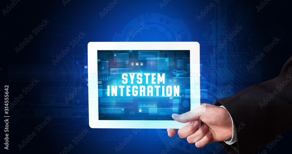 Young business person working on tablet and shows the digital sign: SYSTEM INTEGRATION Young business person working on tablet and shows the digital sign: SYSTEM INTEGRATION