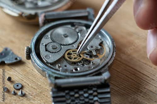 Watchmaker is repairing the wristwatch, mechanical watch