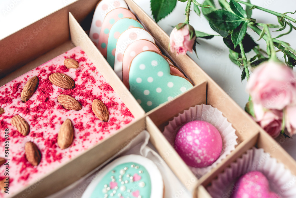 Gift set with hand made sweets in a box on a white table. Flat lay, top view. Gift set with hand made sweets in a box on a white table. Flat lay, top view.