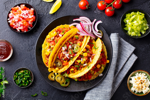 Taco with beef. Mexican traditional cuisine. Dark background. Top view. photo