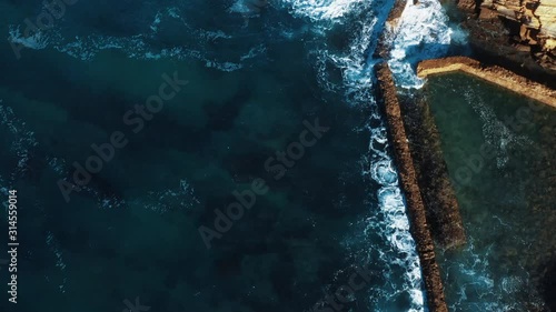 Top Down View Aerial Drone Footage: Portuguese Rocky Shore with Beautiful Ocean View. Abstract Nature, Coastline with Turquoise Waves Rolling on the Sandy Beach. Praia Do Guincho, Praia De Cresmina