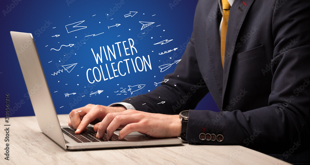 Businessman working on laptop with WINTER COLLECTION inscription, online shopping concept Businessman working on laptop with WINTER COLLECTION inscription, online shopping concept