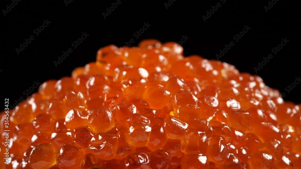 Red caviar rotated over black background. Salmon caviar close up rotation. Salted fish caviar texture. 4K 422 10 bit Red caviar rotated over black background. Salmon caviar close up rotation. Salted fish caviar texture. 4K 422 10 bit