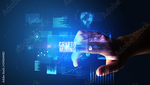 Hand touching CRYPTO MINING inscription, new business technology concept