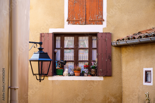 Façade d'une maison en Provence, France. Fenêtre avec des volets, décorée.. 