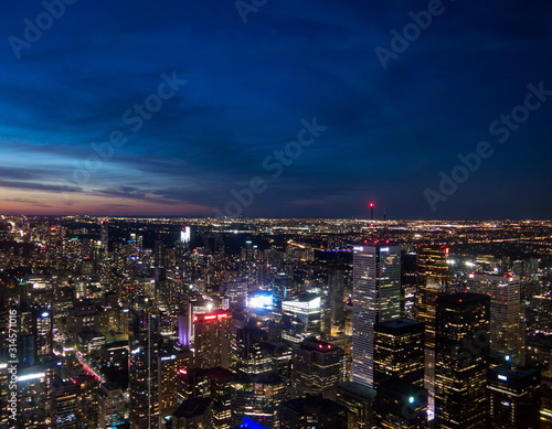 Long exposure aerial view of central Toronto at sunset with lights and car traces visible