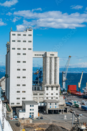 Agribulk vertical silo, unloading towers in port of Savona, Italy