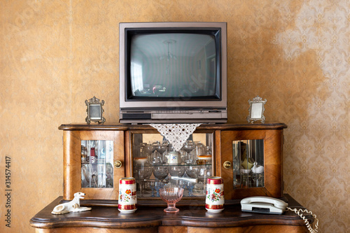 Old fashioned interior - vintage television set on stand