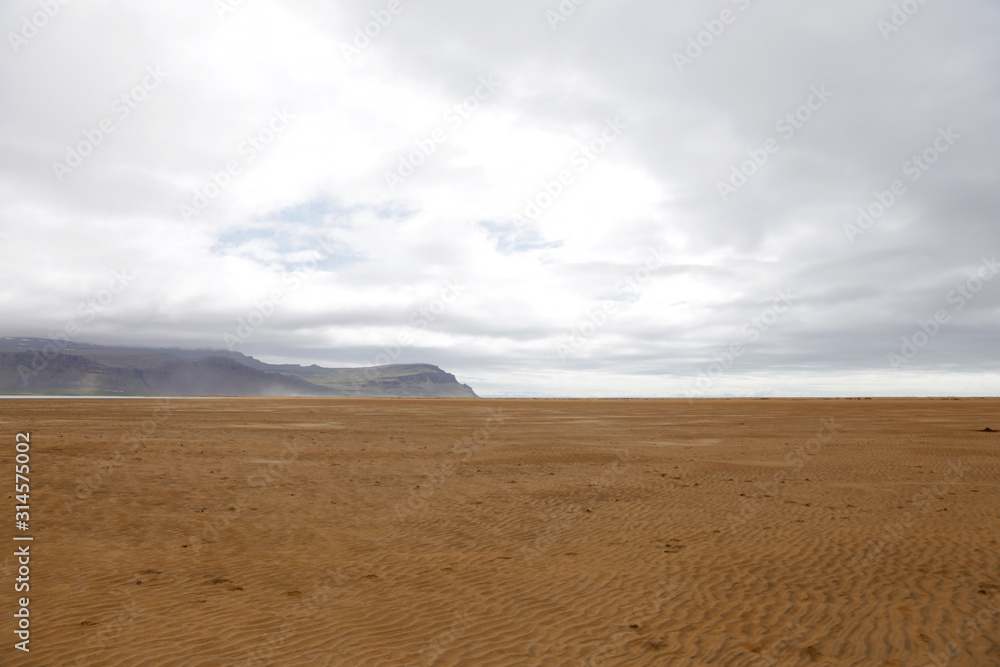 Orange sand beach in Iceland. Rauðisandur (Red Beach) is a 10 kilometer stretch of a beach on the south coast of the West Fjords in Iceland. Orange sand beach in Iceland. Rauðisandur (Red Beach) is a 10 kilometer stretch of a beach on the south coast of the West Fjords in Iceland.