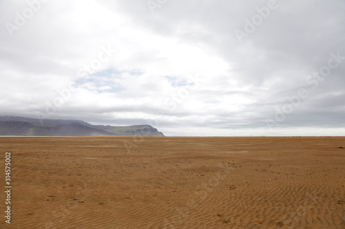 Orange sand beach in Iceland. Rauðisandur (Red Beach) is a 10 kilometer stretch of a beach on the south coast of the West Fjords in Iceland. 