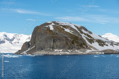 Antarctic landscape with iceberg at sea