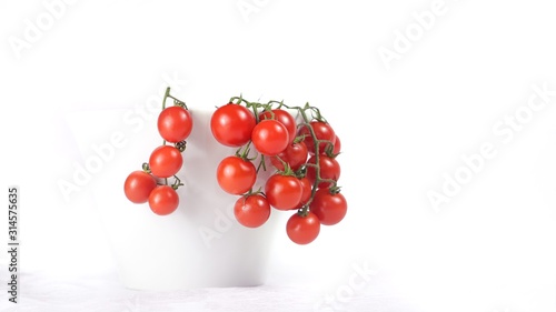 vine tomatoes in a cup with white background