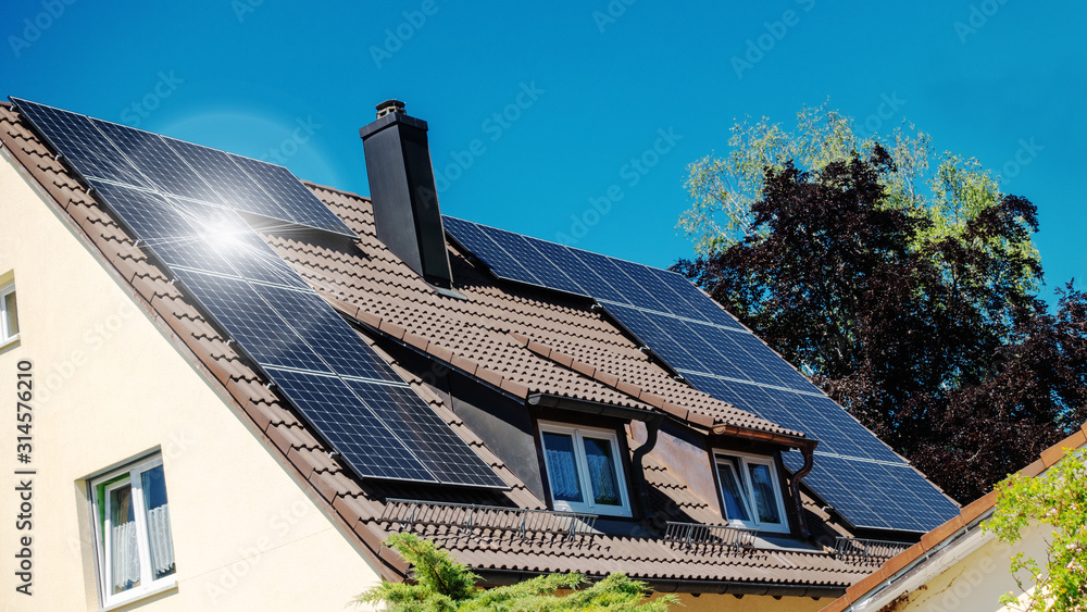 Fototapeta premium a family house with solar panels on the roof