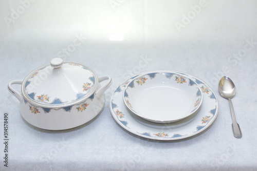 Mock up / design set of elegant and traditional teapot colorful white and blue coffee cup & Tea cup on cup's plate beside the hot tea pot , design/ drink-ware isolated on white background