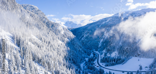 Fototapeta Naklejka Na Ścianę i Meble -  Magical Switzerland winter lake in the middle of the Alps surrounded by the magical forest covered in snow.