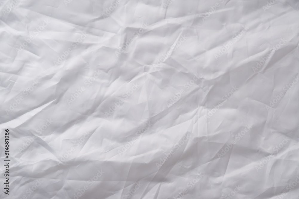 Texture of crumpled white fabric with a blue tint. White flag, reflector. Creative vintage background. Texture of crumpled white fabric with a blue tint. White flag, reflector. Creative vintage background.