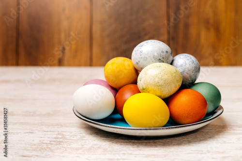 Plate full of multi coloured and mottled Easter eggs