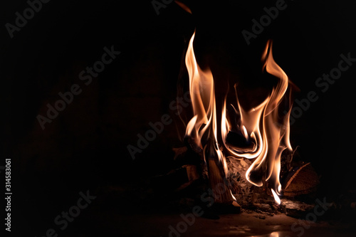 Close-up of beautiful dancing flames in the fireplace at night
