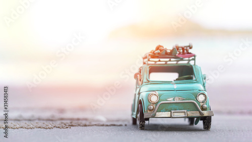 Miniature  tin car  closeup at summer beach scene