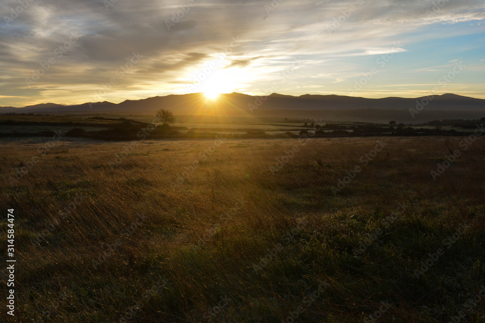 Landscape during sunrise with mountains on the horizon in a small town of Salamanca, Spain Landscape during sunrise with mountains on the horizon in a small town of Salamanca, Spain