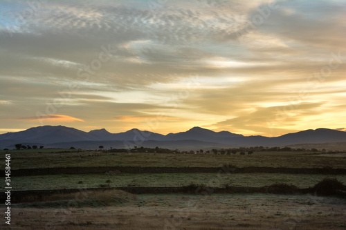 Landscape during sunrise with mountains on the horizon