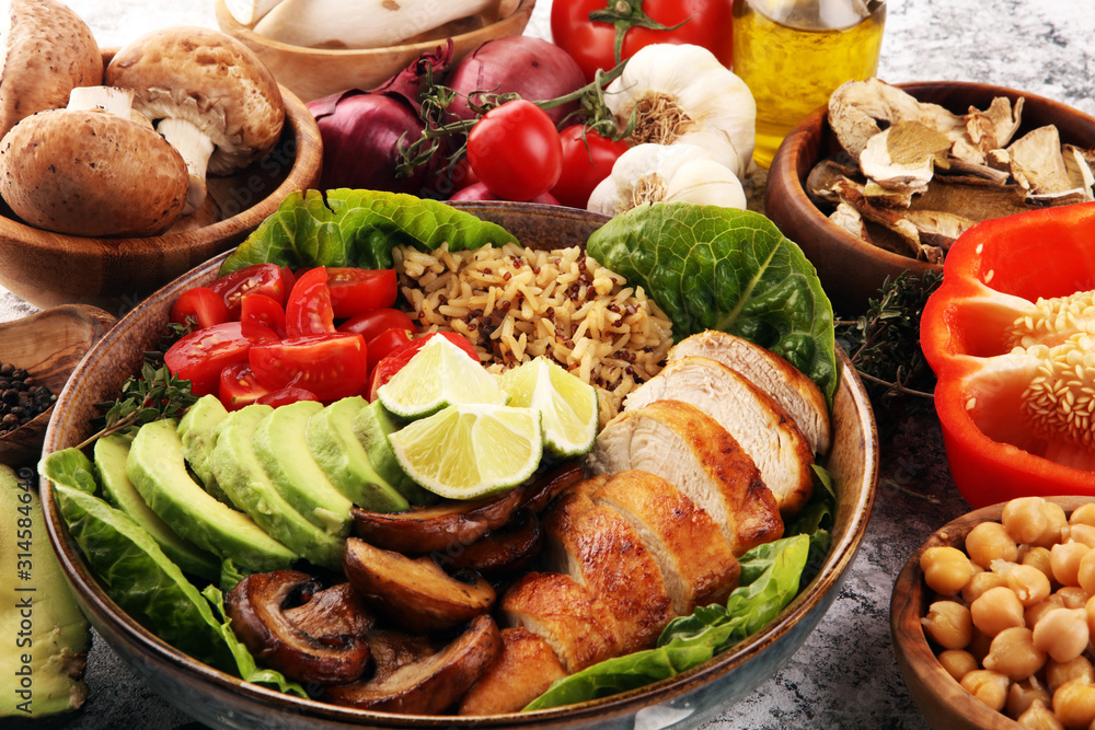 Healthy salad bowl with quinoa, tomatoes, chicken, avocado, lime and mixed greens and mushrooms Healthy salad bowl with quinoa, tomatoes, chicken, avocado, lime and mixed greens and mushrooms