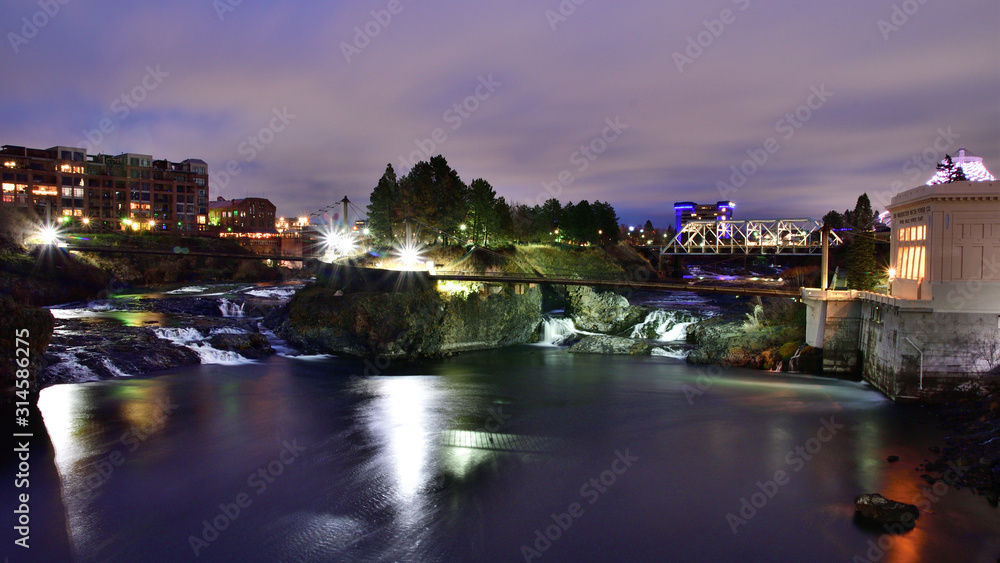 Long exposure, sunrise photo of Spokane Falls on the Spokane River looking over Riverfront Park in downtown Spokane, Washington 