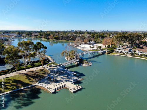 Aerial view of North Lake surrounded by residential neighborhood during blue sky day in Irvine, Orange County, USA