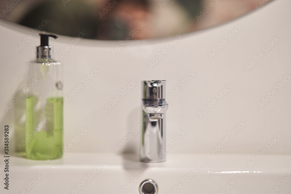Silver chrome tap and washbasin in the bathroom. Interior Design Silver chrome tap and washbasin in the bathroom. Interior Design