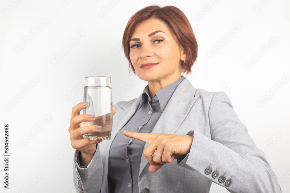 Happy beautiful business woman offers a glass of water. Thirst and health. Happy beautiful business woman offers a glass of water. Thirst and health.