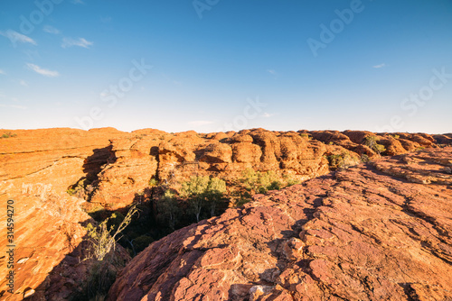 Lookout over the canyon of red arid earth in the bright sun