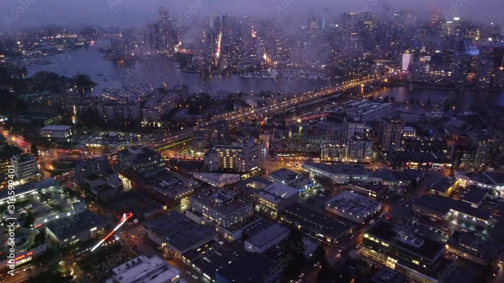 Aerial view of False creek and Cambie bridge with traffic through clouds Aerial view of False creek and Cambie bridge with traffic through clouds