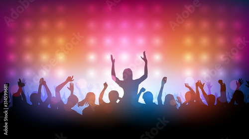 Silhouette of people raise hand up dancing in concert with spotlight on stage background