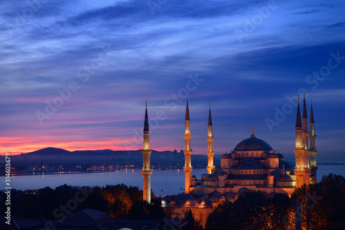 Lights on the Blue Mosque with red sky in the morning on the Bosphorus Sultanahmet Istanbul Turkey