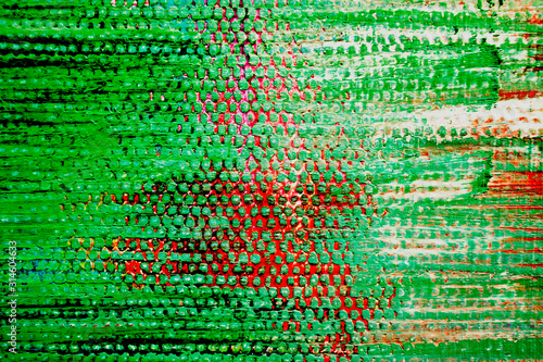 Bright green textured background  a little red. Canvas with paint. Abstract background.