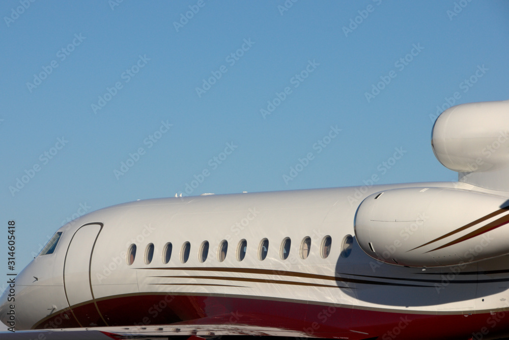 A personal jet against a blue sky A personal jet against a blue sky