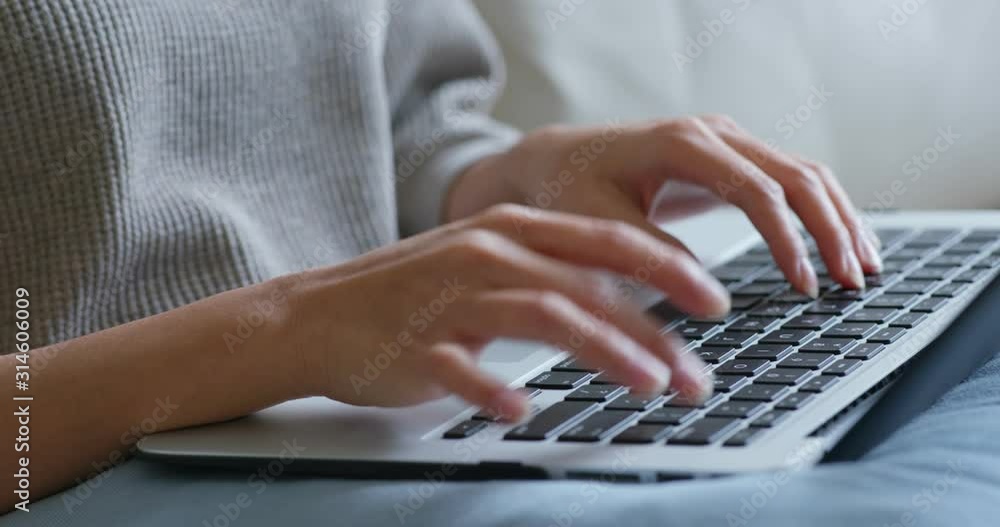 Woman type on notebook computer at home
