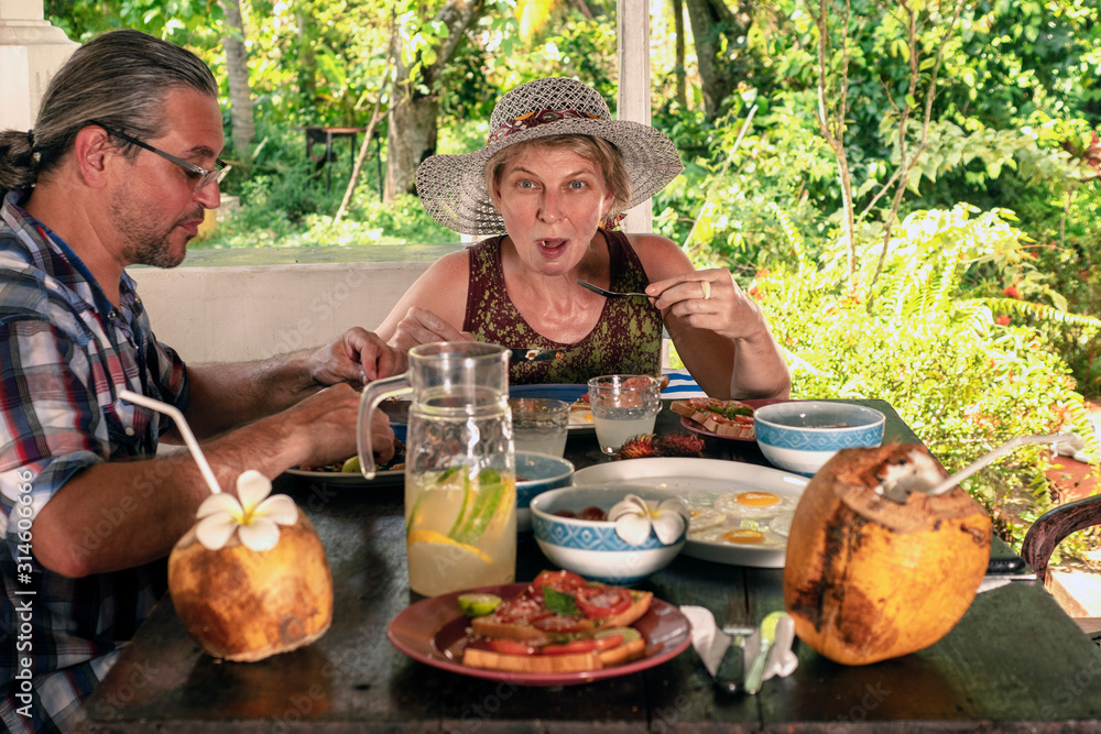 Surprised woman and man having lunch in the garden Surprised woman and man having lunch in the garden