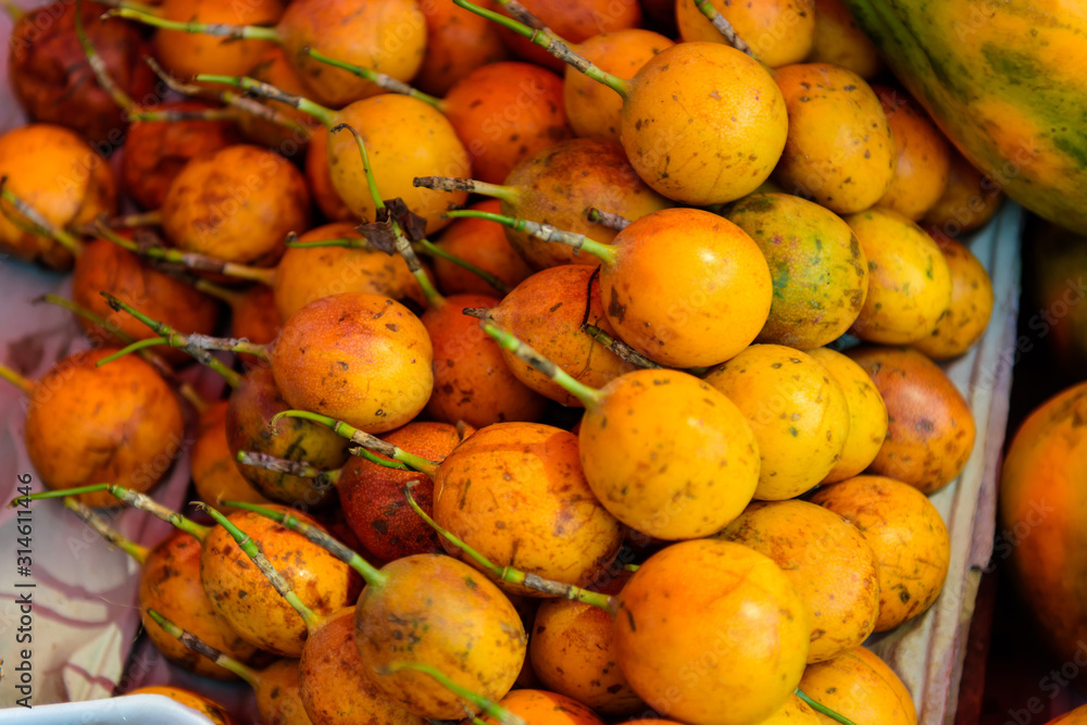 Ripe passion fruit at street market in Asia. Yellow passion fruit in India. Sweet tropical fruits.